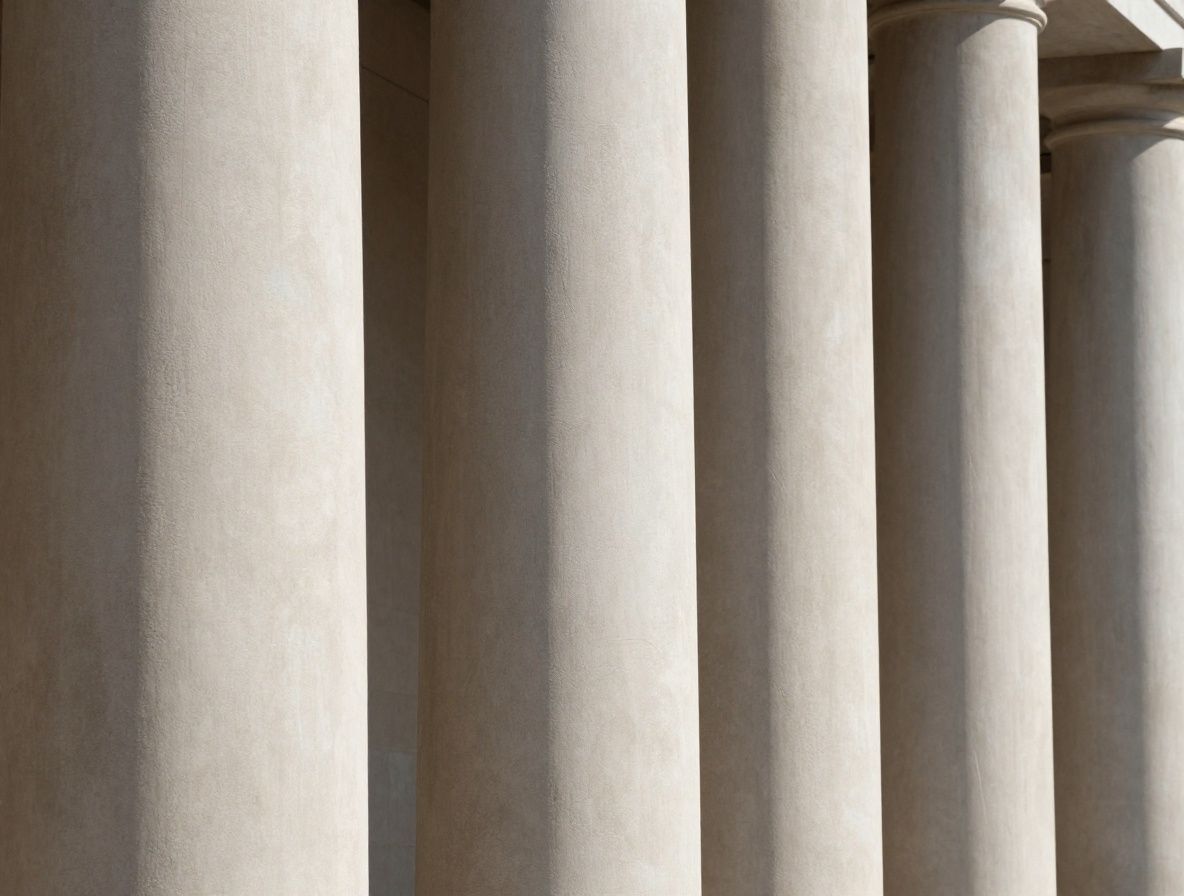 Abstract close-up of architectural columns with strong geometric shadows creating a sense of structure and order